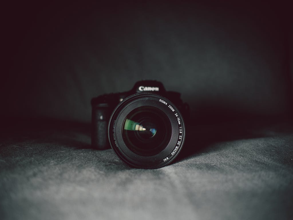 A camera lens in focus against a dark background, highlighting the optical details.