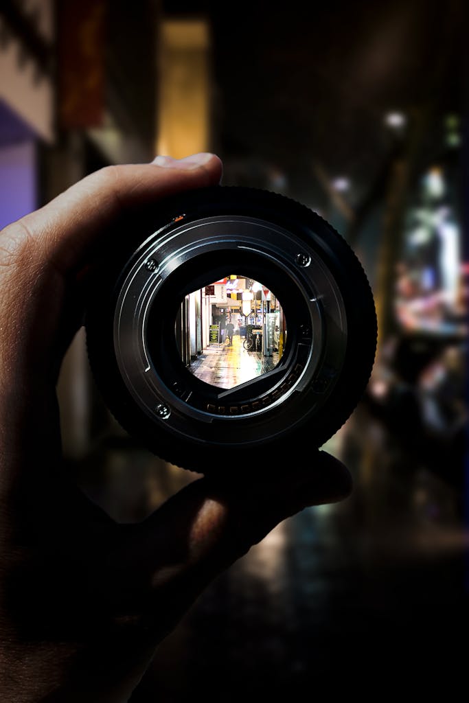 A unique perspective of Düsseldorf's city streets seen through a camera lens at night.